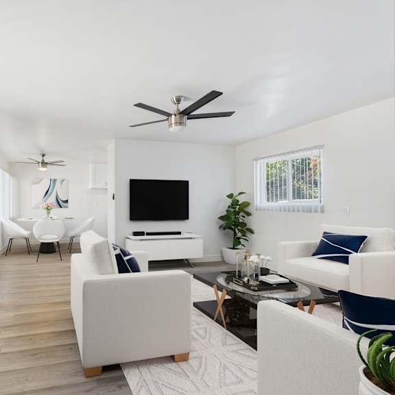 a living room with a white couch and a television.