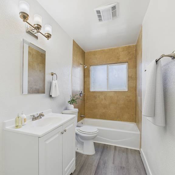a bathroom with a white sink and toilet.