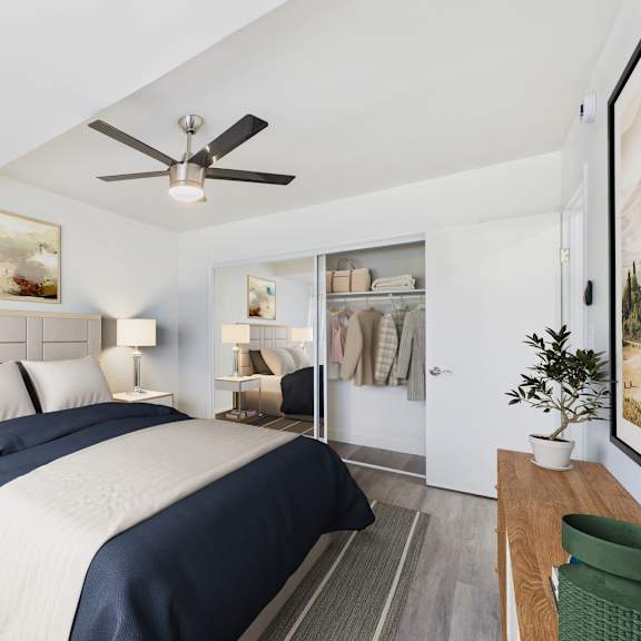 a bedroom with a large bed and a ceiling fan.