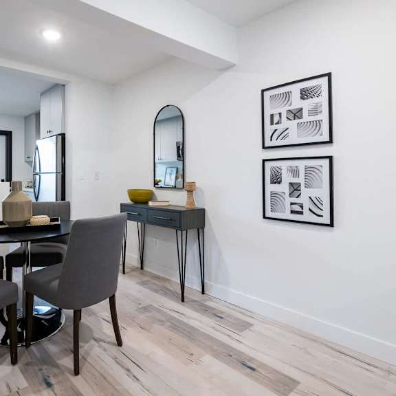a dining room with a table and chairs.