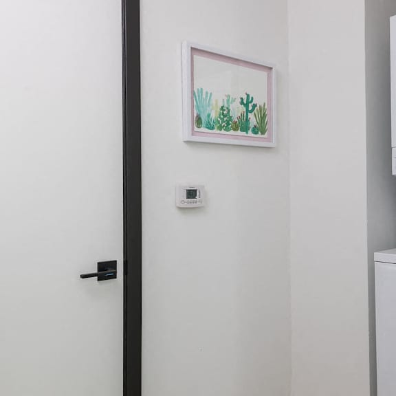 a white washing machine sits next to a white door.
