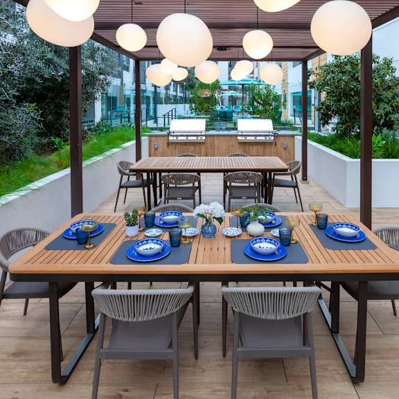 a table set for a meal with blue plates and napkins.