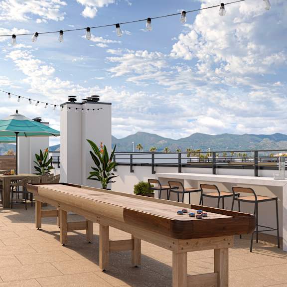 a shiny pool table is in the middle of a patio with a view of the mountains.