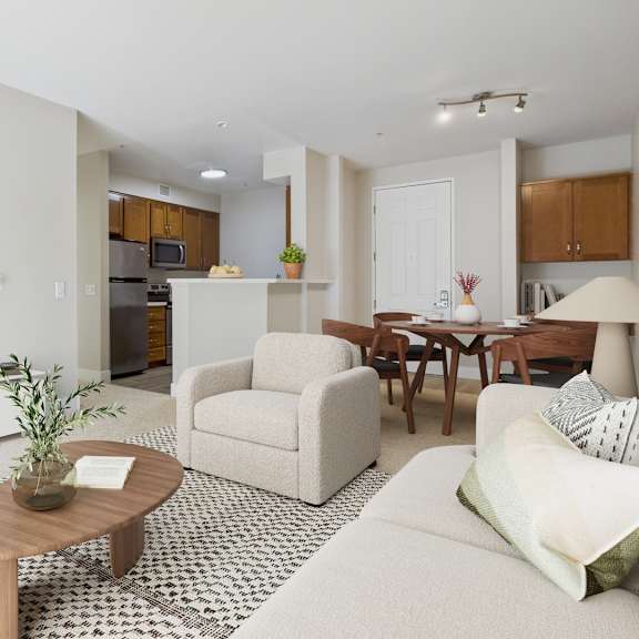 a living room with a white couch, a wooden coffee table, and a television.