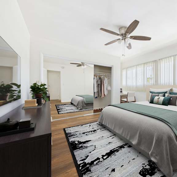 a bedroom with a large bed and a ceiling fan.