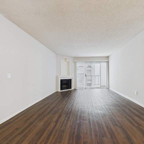 a room with wooden floors and white walls.