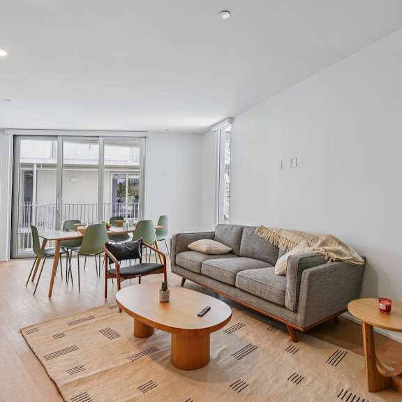 a living room with a grey couch and a coffee table.