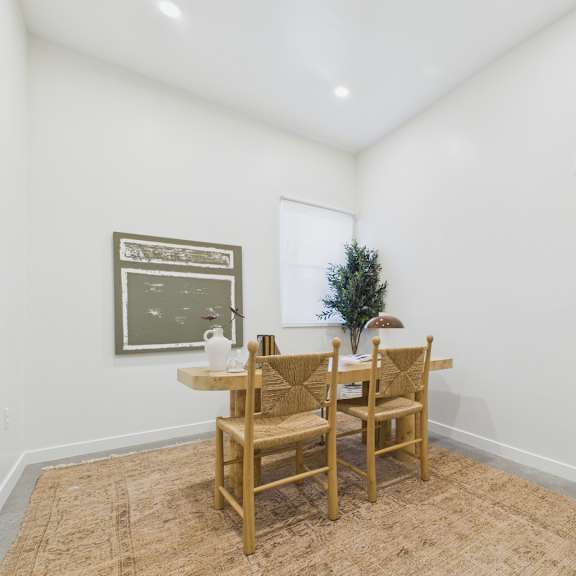 a dining room with a table and chairs.