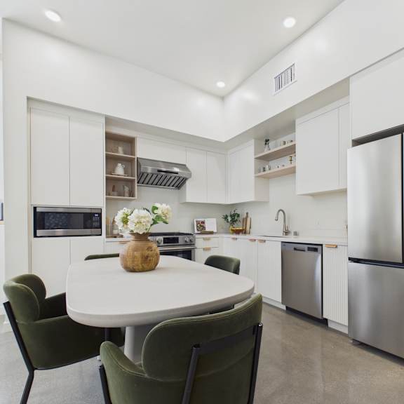a modern kitchen with a table and chairs.