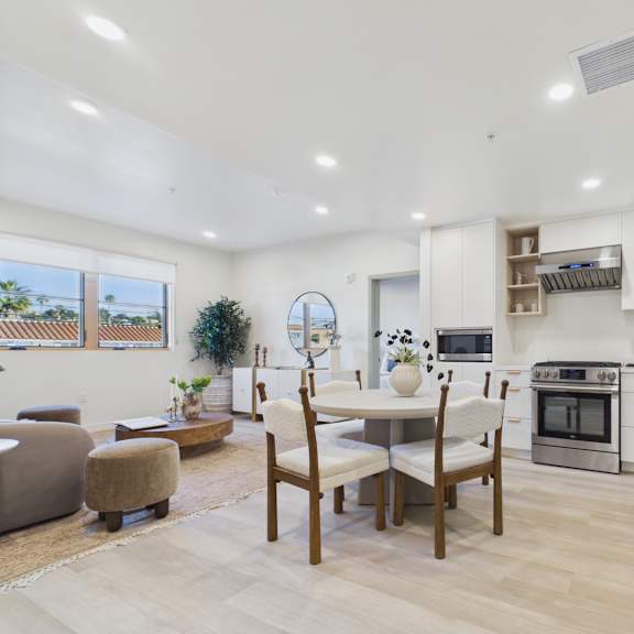 a modern kitchen with a dining table and chairs.