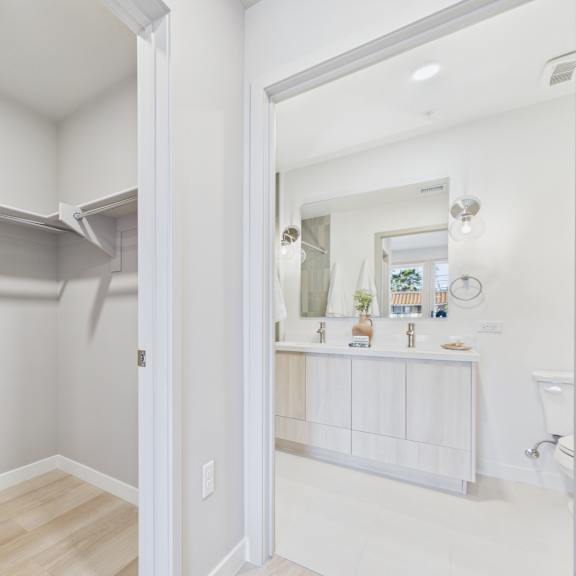 a white bathroom with a white cabinet and a white sink.