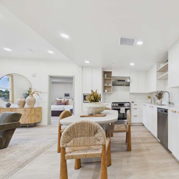 a modern kitchen with a dining table and chairs.