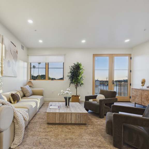 a living room with a couch, chairs, and a coffee table.