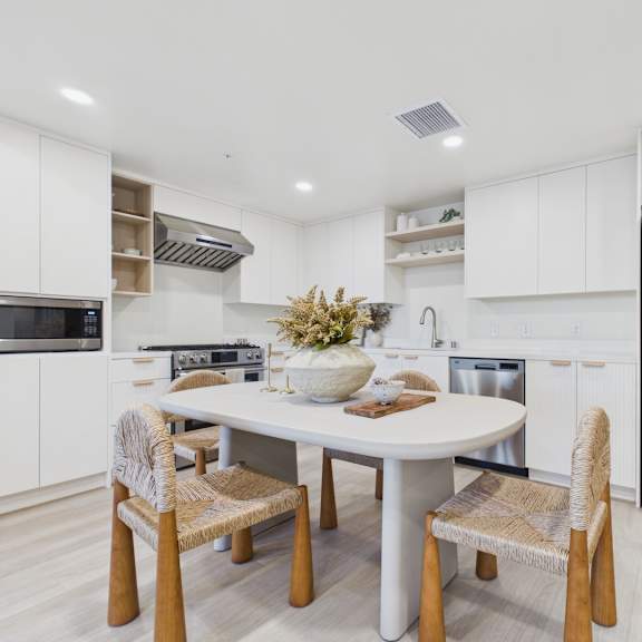 a modern kitchen with a table and chairs.