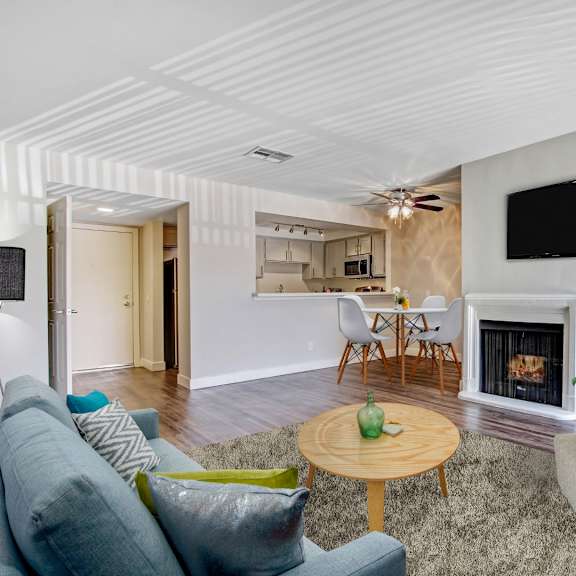 a living room with a fireplace and a television.