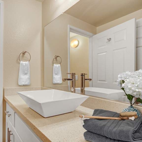 a white bathroom with a white tub and sink.
