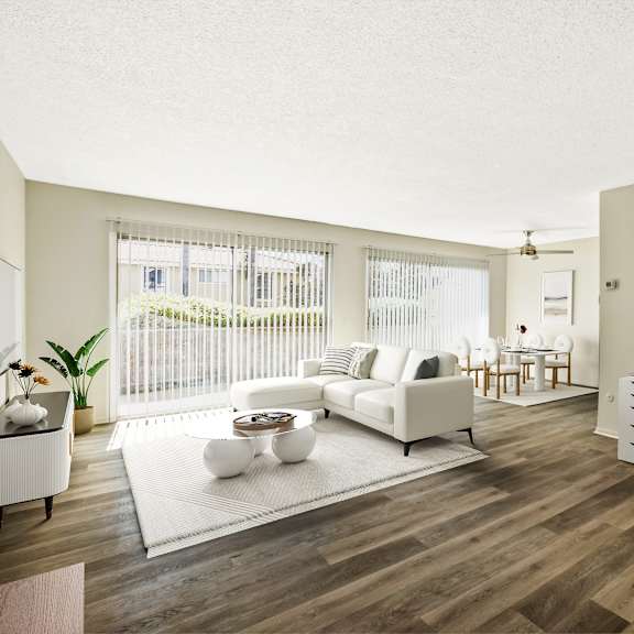 a living room with a couch and a desk and a window