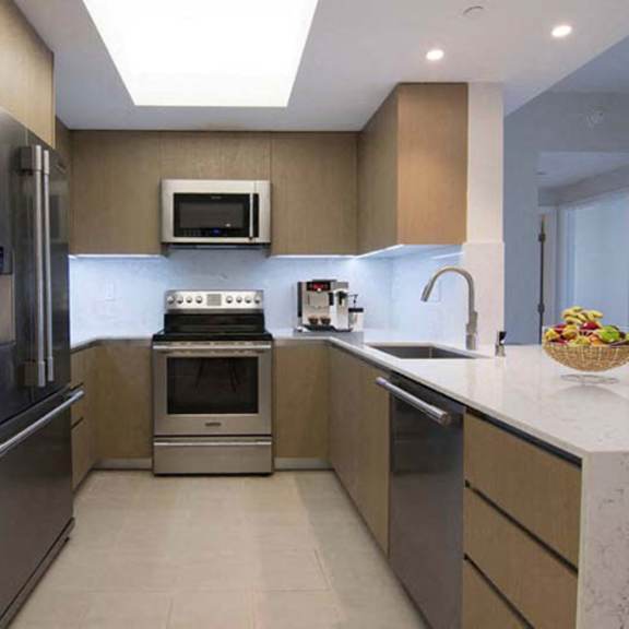 Thumbnail 1 of 7 a kitchen with stainless steel appliances and a sink at Wilshire Margot, Los Angeles, 90024