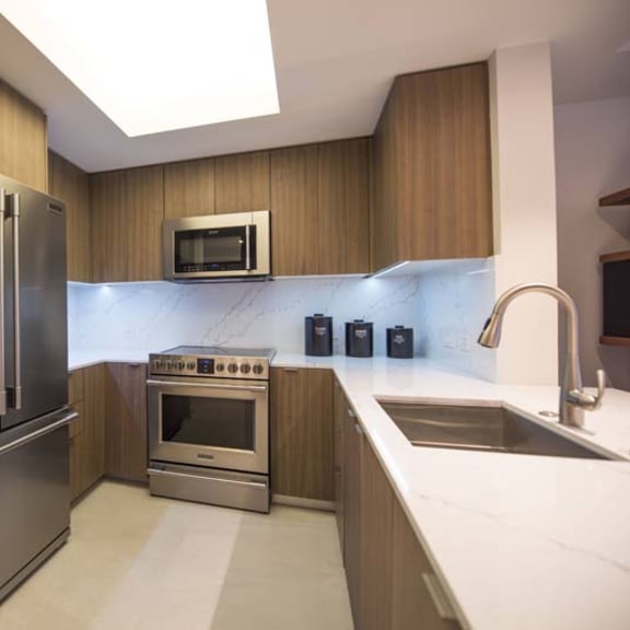Thumbnail 3 of 8 a kitchen with stainless steel appliances and a sink
