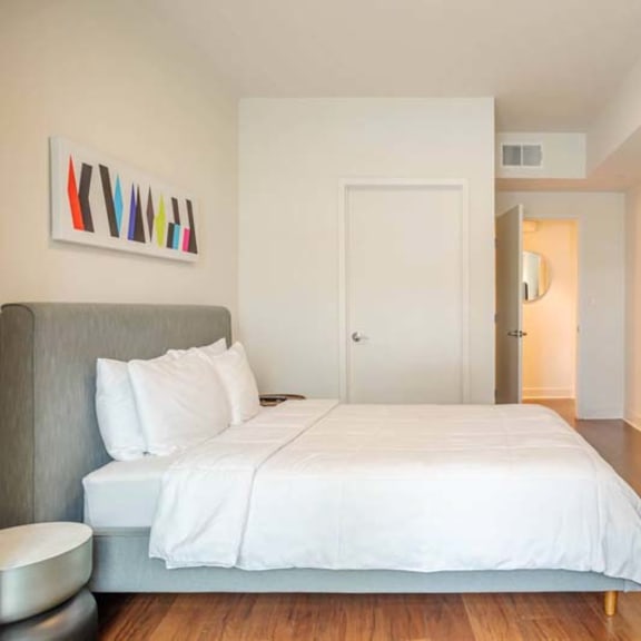 Thumbnail 3 of 7 a bedroom with a large bed and a tv