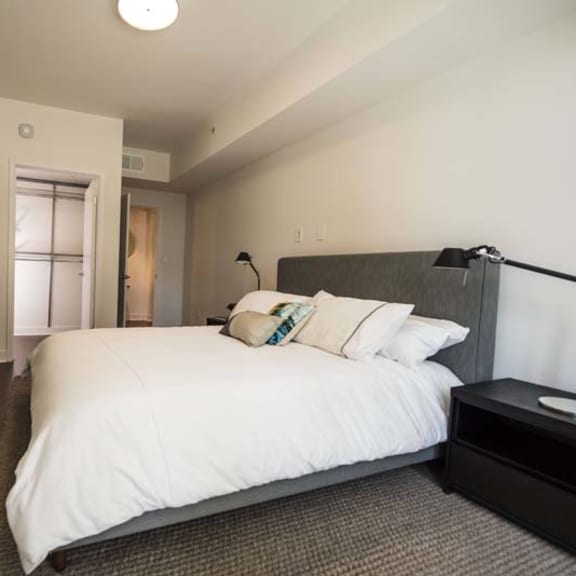 Thumbnail 6 of 8 a bedroom with a large white bed and a dresser
