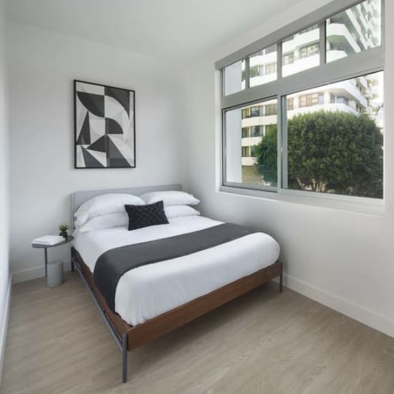 Thumbnail 8 of 9 a bedroom with a bed and a window