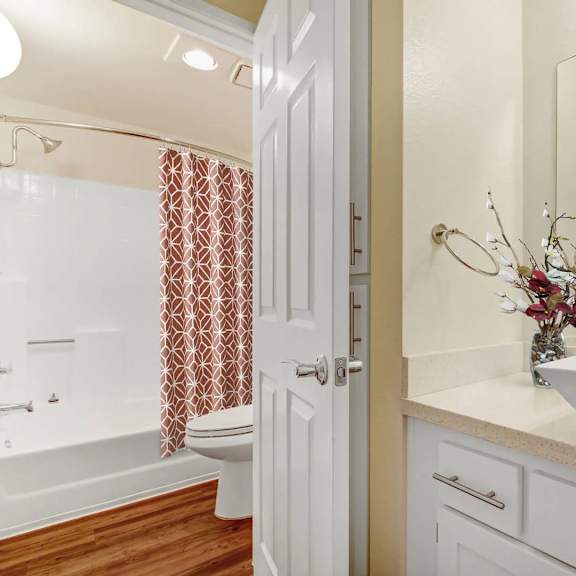 a white bathroom with a white sink and a white toilet.