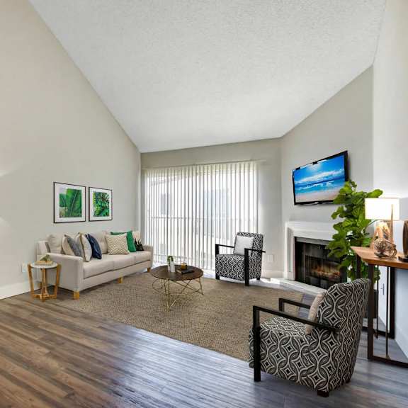 a living room with a fireplace and a television.