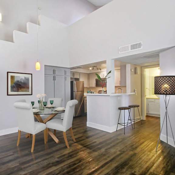 a dining room with a white table and chairs.