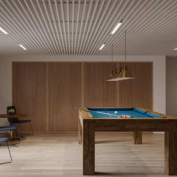 a billiard table is in the middle of a room with a blue chair and a brown chair.