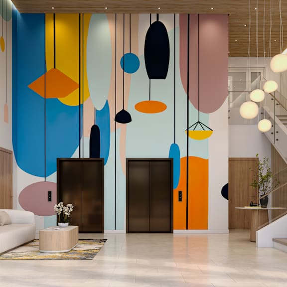 a modern interior with a staircase, a sofa, a table, and a large painting on the wall.