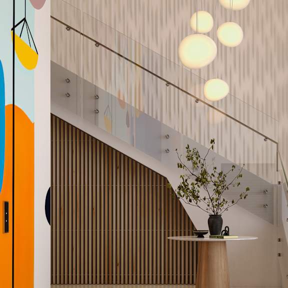 a staircase with a flower vase on the landing.