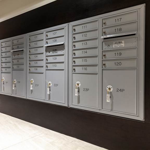 a row of mailboxes are lined up against a wall.