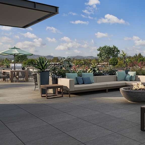 a patio with a fire pit and seating area.