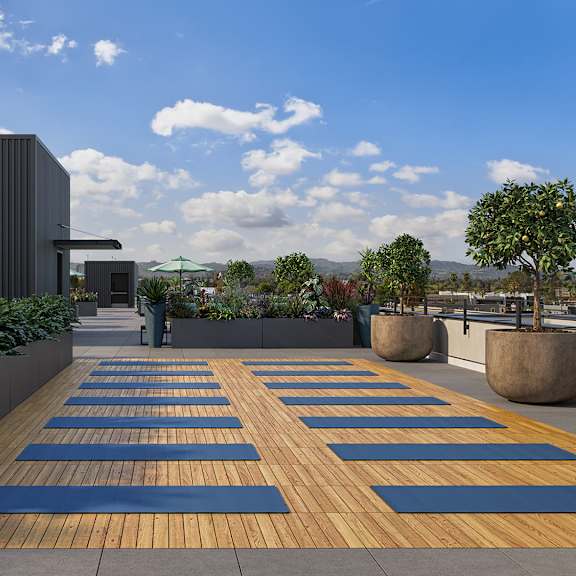 a yoga mat is laid out on a wooden deck.
