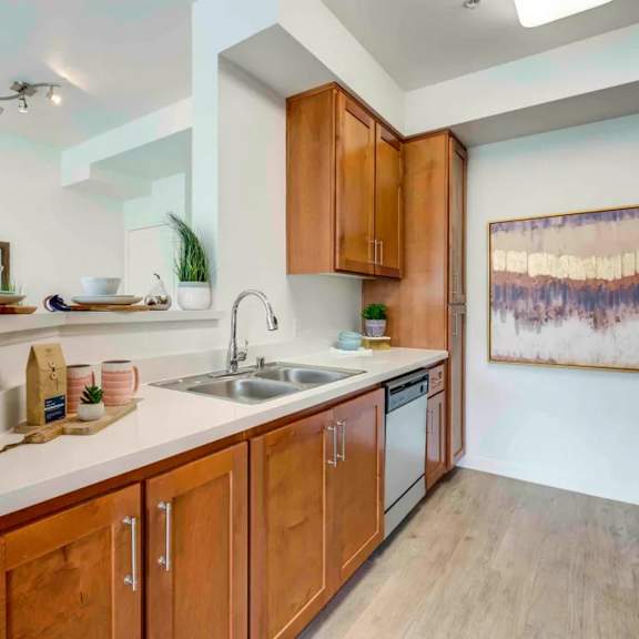 a kitchen with wooden cabinets and a white countertop.