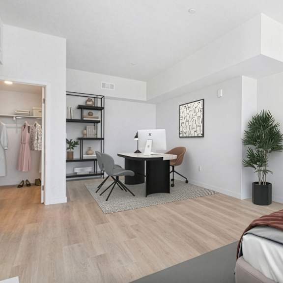 a bedroom with a bed, desk, and chair.
