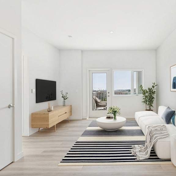 a modern living room with a white sofa, a wooden tv stand, and a large window.