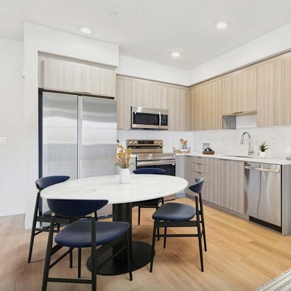 a modern kitchen with a dining table and chairs.