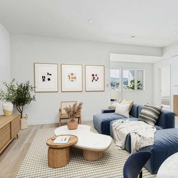 a living room with a blue couch and a coffee table.