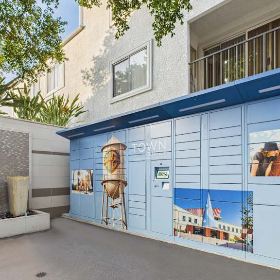a wall with a mural of a town scene.