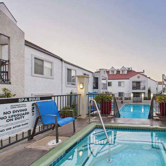 a pool with a sign that says spa rules.