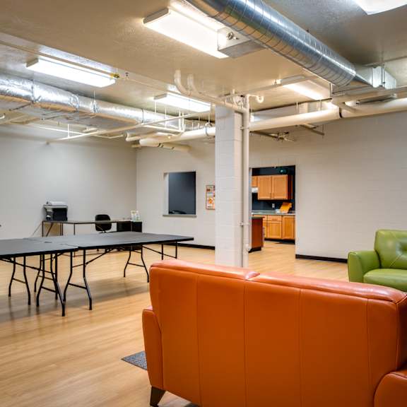 a game room with a ping pong table and couches