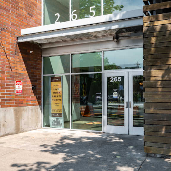 the entrance of a building with glass doors and a sign in the window