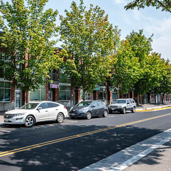 a city street with cars parked in front of buildings