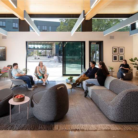 a group of people are sitting in a modern lounge area.