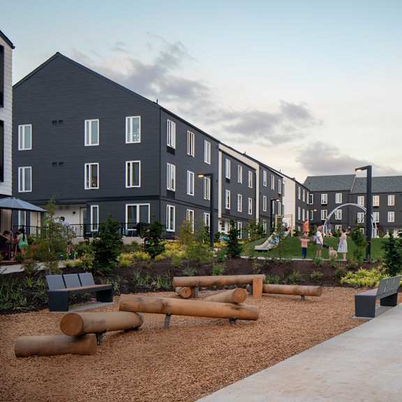 a modern residential area with apartment buildings and a playground.
