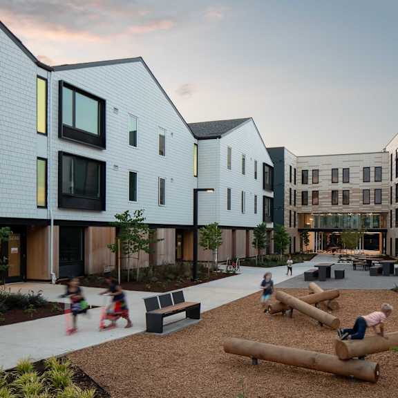 a modern residential area with children playing in the playground.