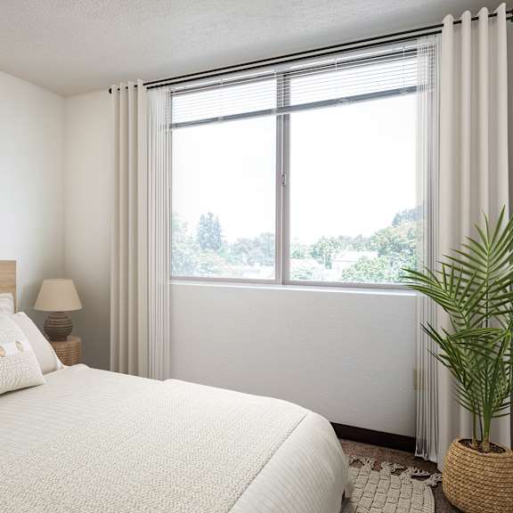 a bedroom with a bed and a large window
