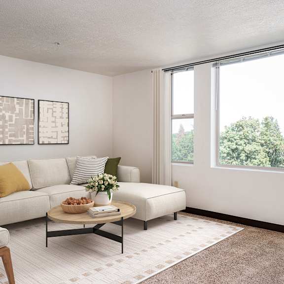 a living room with a large window and a white couch